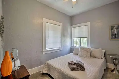 a bedroom with a bed and two windows at Entire Building Sleeps 20 I Little Italy in San Diego