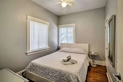 a bedroom with a bed with a pair of shoes on it at Entire Building Sleeps 20 I Little Italy in San Diego