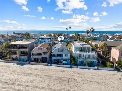 an aerial view of a beach with houses and the ocean at Cozy 2BR Bayfront Home | Patio + Water Views in Mission Beach in San Diego