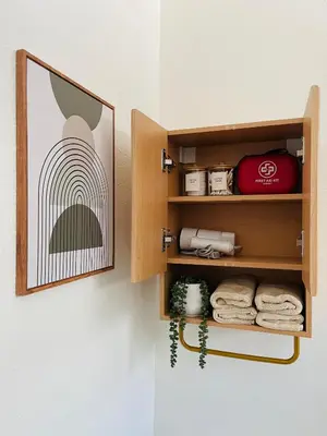 a cabinet with towels and a picture on the wall at The North Park Stay in San Diego in San Diego