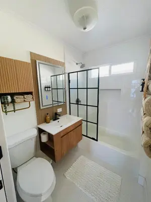 a bathroom with a toilet and a sink and a tub at The North Park Stay in San Diego in San Diego