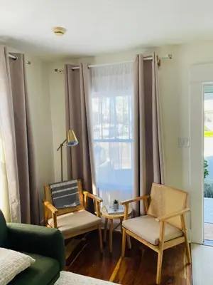a living room with two chairs and a window at The North Park Stay in San Diego in San Diego