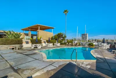 a swimming pool with tables and chairs in a resort at Marina Del Mar 203A in Oceanside