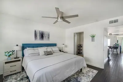 a white bedroom with a bed and a ceiling fan at Marina Del Mar 203A in Oceanside