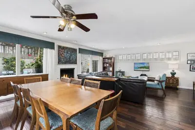 a dining room with a table and a living room at 5Br Retreat With Balcony And Patio, 2 Homes From Sand By Beachview Rentals in Newport Beach