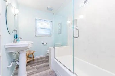 a white bathroom with a sink and a shower at Coastal 4Br Retreat, Just Steps From 44Th St Beach in Newport Beach