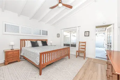 a bedroom with a bed and a ceiling fan at Bayfront 3Br With Harbor Views, Only Steps To The Beach By Beachview Rentals in Newport Beach