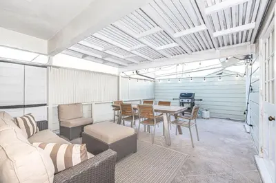 a dining room with a table and chairs at Bayfront 3Br With Harbor Views, Only Steps To The Beach By Beachview Rentals in Newport Beach