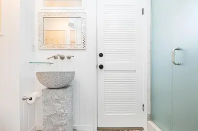 a bathroom with a sink and a mirror at 3Br Oceanfront Home W Patio Right On The Sand By Beachview Rentals in Newport Beach