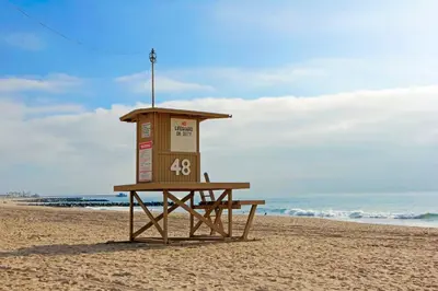 a lifeguard stand on a beach with the ocean at 3Br Oceanfront Home W Patio Right On The Sand By Beachview Rentals in Newport Beach