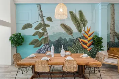 a dining room with a table with chairs and a mural at Downtown Gaslamp Getaway Stylish 4BR APT in San Diego