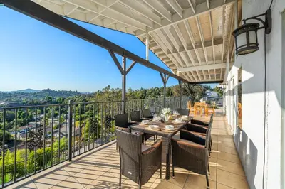 a patio with a table and chairs on a balcony at Entire Private Home with 4 Bedrooms 2 Bathrooms, Pool, View, 4 Parking, King Bed, Big Yard, Available Now in El Cajon