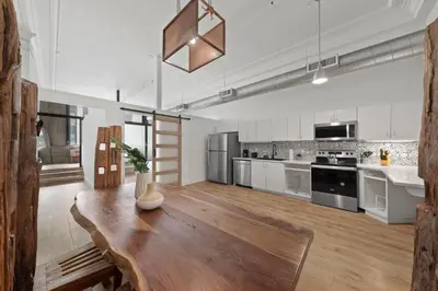 a large kitchen with a wooden table in a room at Party in Gaslamp 4BR Downtown Pad with Bathtub in San Diego