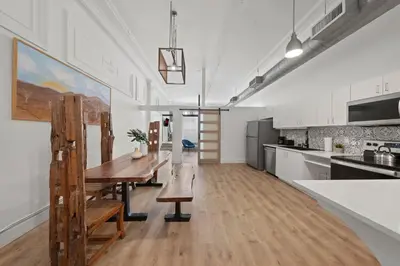 a kitchen with a wooden table and a dining room at Party in Gaslamp 4BR Downtown Pad with Bathtub in San Diego