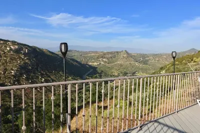 a balcony with a view of the mountains at Quiet Hilltop Home With Stunning Hill Top And Valley Views in Valley Center