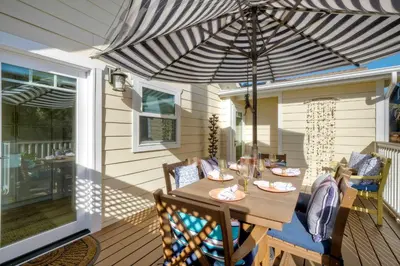 a patio with a table and an umbrella at Monarch Cove - Unit A For 7ppl in Oceanside
