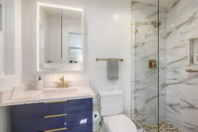 a bathroom with a toilet and a sink and a shower at Monarch Cove - Unit B For 2ppl in Oceanside