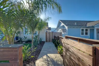 a wooden fence in front of a house at Monarch Cove - Unit B For 2ppl in Oceanside