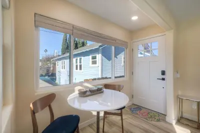 a dining room with a table and a large window at Monarch Cove - Unit B For 2ppl in Oceanside
