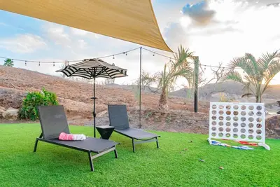 two chairs and an umbrella on the grass at Vista Oasis with Spa, Pool, & Views in Vista