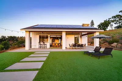 a house with a solar roof on a lawn at Vista Oasis with Spa, Pool, & Views in Vista