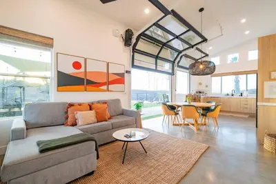 a living room with a couch and a table at Vista Oasis with Spa, Pool, & Views in Vista