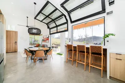 a kitchen and dining room with a table and chairs at Vista Oasis with Spa, Pool, & Views in Vista