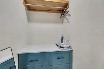a blue cabinet with a mirror on a wall at ON Avenida Del Mar Heart of Downtown 10 minute WALK to the Pier Parking in San Clemente
