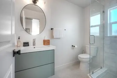 a white bathroom with a sink and a mirror at Sycamore Haus Estate – Rent All 3 Ocean-View Luxury Condos Steps from Carlsbad State Beach in Carlsbad