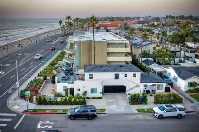 an aerial view of a house and the ocean at Sycamore Haus Estate – Rent All 3 Ocean-View Luxury Condos Steps from Carlsbad State Beach in Carlsbad