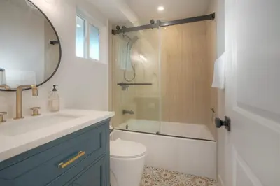 a bathroom with a sink and a toilet and a shower at Luxury Carlsbad Retreat | Across The Street From Beach | Firepit, BBQ, Ping Pong, Cornhole & More in Carlsbad