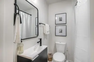 a bathroom with a sink and a toilet and a mirror at Modern Carlsbad Vacation Rental with Ocean Views, Private Patio, Fire Pit & Walkable Location in Carlsbad