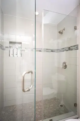 a shower with a glass door in a bathroom at Pier View Sunset - Ocean Front, Patios, Location, Views in San Diego