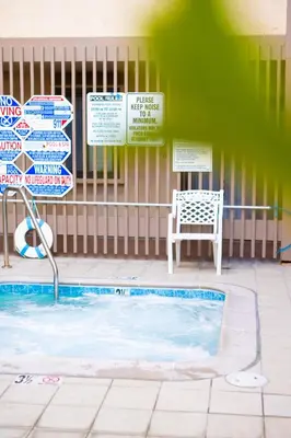 a swimming pool with a chair next to a building at Pier View Sunset - Ocean Front, Patios, Location, Views in San Diego