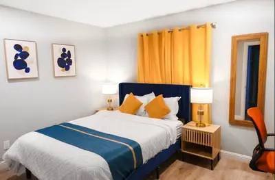 a bedroom with a blue and white bed and two lamps at Escondido Front Unit 3-BR by SD STAY in Escondido