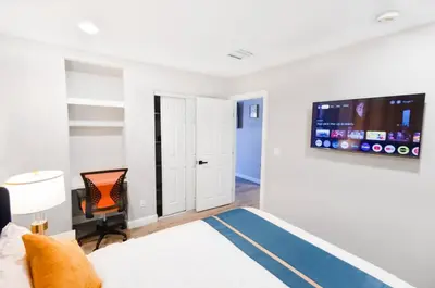 a bedroom with a bed and a flat screen tv on the wall at Escondido Front Unit 3-BR by SD STAY in Escondido