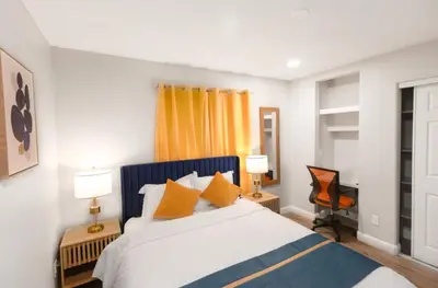 a bedroom with a large bed with orange pillows at Escondido Front Unit 3-BR by SD STAY in Escondido
