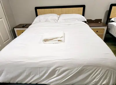 a white bed with a white towel on it at Escondido Front Unit 3-BR by SD STAY in Escondido