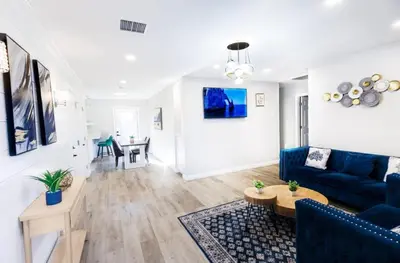 a living room with a blue couch and a table at Escondido Front Unit 3-BR by SD STAY in Escondido