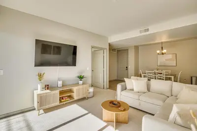 a living room with a white couch and a table at By Seaport Village and Navy Base! Chic Condo with Pool in National City