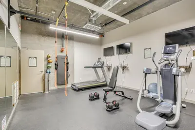 a gym with treadmills and machines in a room at By Seaport Village and Navy Base! Chic Condo with Pool in National City