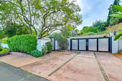 a house with a gate and a driveway at Gather and Unwind Outdoors, Stylish Vista Retreat! in Vista