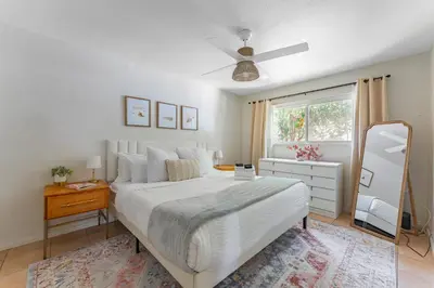 a bedroom with a large bed and a window at Light & Airy by Coastline Vacation Rentals in San Diego