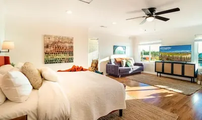 a bedroom with a large bed with a ceiling fan at Hilltop Wine Estate- Pickleball - Pool - 360 views in Temecula