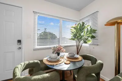 a dining room with a table and chairs and a window at Stylish 1BR Home with Parking Near Zoo & Downtown in San Diego