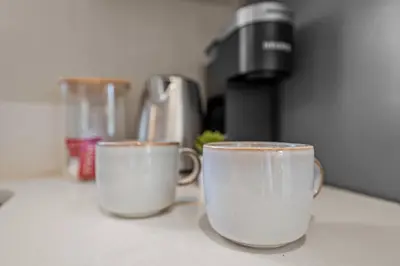 two cups of coffee sitting on top of a counter at Stylish 1BR Home with Parking Near Zoo & Downtown in San Diego