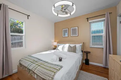 a bedroom with a large bed and a window at Stylish 1BR Home with Parking Near Zoo & Downtown in San Diego