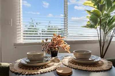 a table with three cups and plates on top of it at Stylish 1BR Home with Parking Near Zoo & Downtown in San Diego