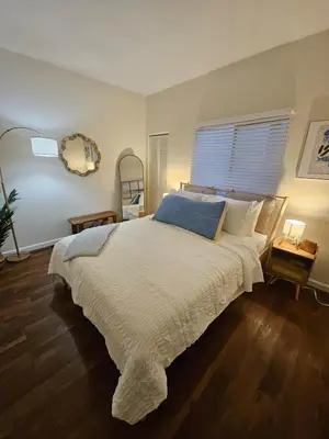 a bedroom with a large bed and a window at The Seabreeze by Coastline Vacation Rentals in San Diego