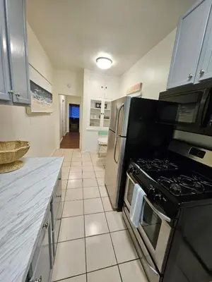a kitchen with a stove and a counter top at The Seabreeze by Coastline Vacation Rentals in San Diego